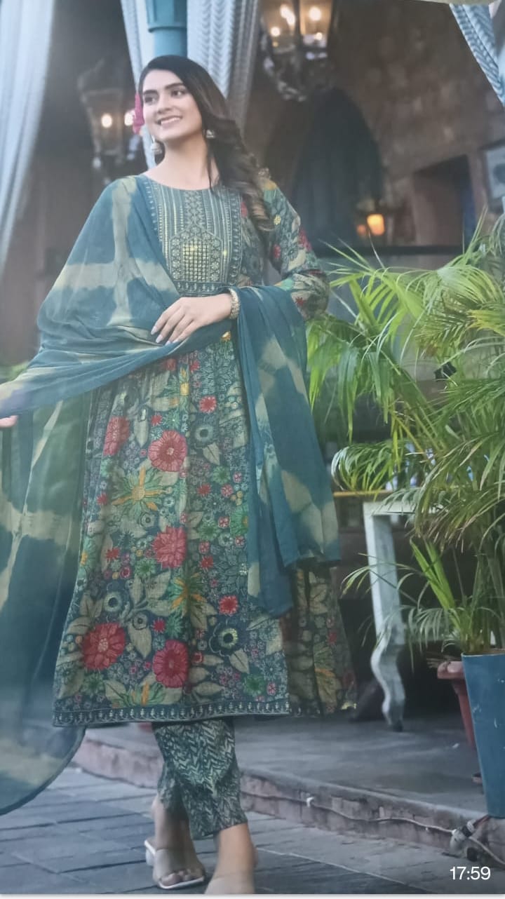 Woman wearing a traditional outfit with floral  green color design in an outdoor setting