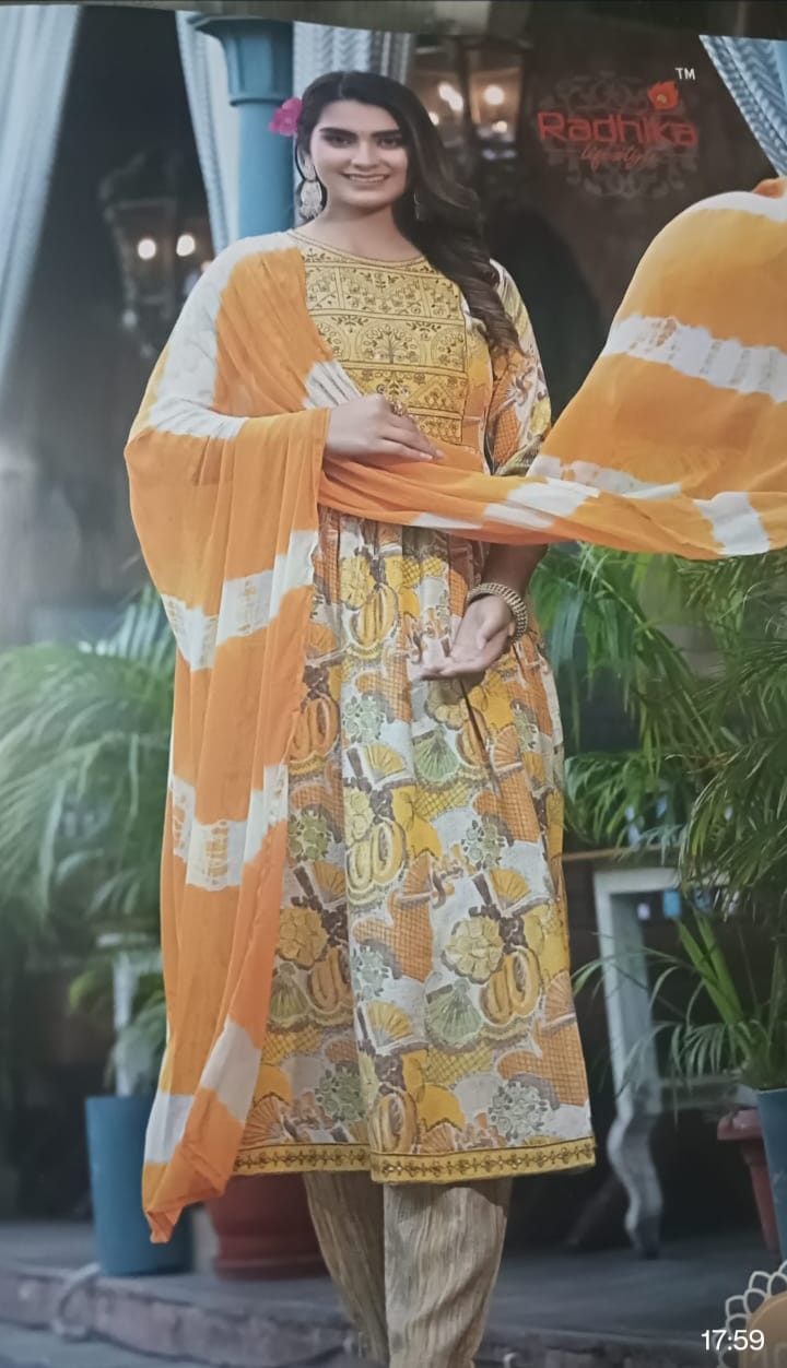 Yellow and white patterned outfit with a blurred background in cotton rayon kurti pant set