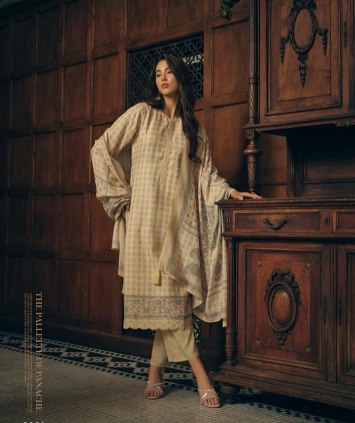 Woman in a traditional outfit standing next to a wooden cabinet